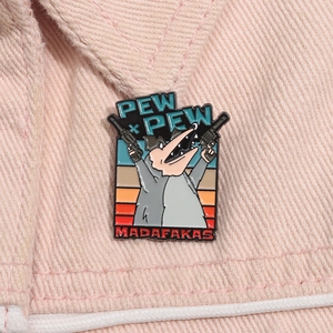 Macro shot of a cartoon opossum enamel pin with Pew Pew text on pink denim fabric