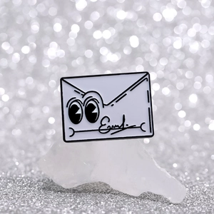 Cute white envelope metal brooch featuring cartoon big eyes and artistic signature on crystal