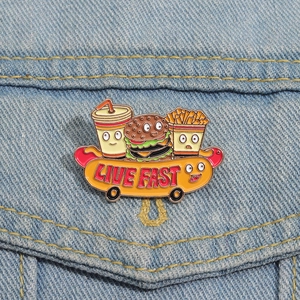 Creative cartoon fast food enamel pin with 'Live Fast' text on blue denim fabric