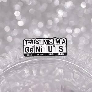 Science enamel pin featuring TRUST ME, I'M A GENIUS spelled with chemical elements