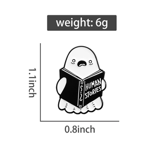 Ghost reading book enamel pin with Human Stories text and 1.1-inch size measurement