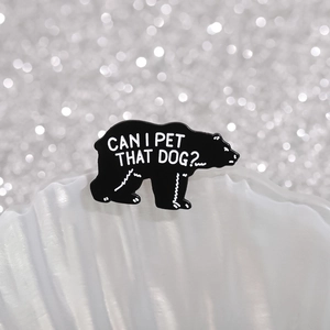 Black bear enamel pin with Can I Pet That Dog? funny text on white shell pedestal