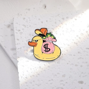 Cartoon duck enamel pin with pink money bag and sun hat on white stone base