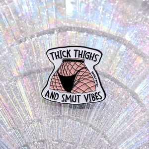 Quirky fishnet stockings enamel pin with Thick Thighs and Smut Vibes text design