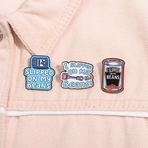 Detail of Bluey enamel pins with funny quotes on a light pink denim jacket collar