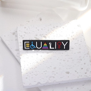 Equality enamel pin with rainbow stripes and diversity symbols on a white stone background