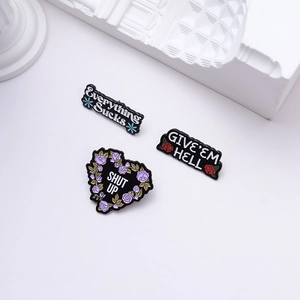Three-piece black enamel pin set with flower motifs and witty text for clothing decor