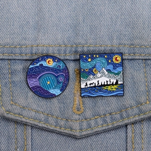 Detail of Starry Night style Hobbit enamel pins on a denim jacket pocket