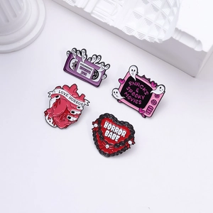 Pink punk Halloween enamel pin set with horror fan theme, tapes, and hearts