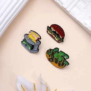 Three-piece set of enamel pins with creative burger and toaster money themed designs