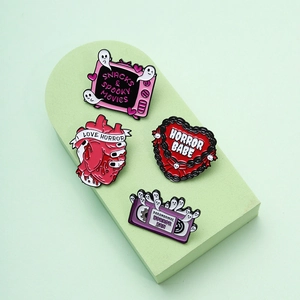 Set of four horror-themed enamel pins featuring heart, ghost TV, and cassette motifs
