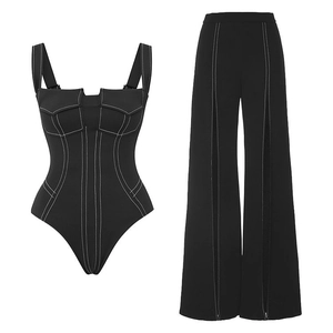 Detail view of black bodysuit and wide-leg trousers set with white contrast stitching