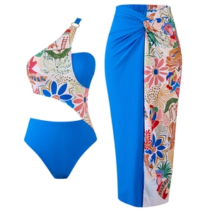 Detailed view of 3-piece tropical floral swimsuit set with blue one-shoulder top and sarong