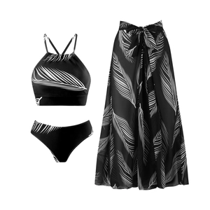 Three-piece bikini set with black and white leaf print including matching sarong wrap skirt