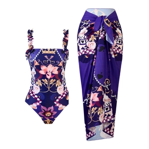 Detail view of purple floral swimsuit and matching long sarong skirt with crown print