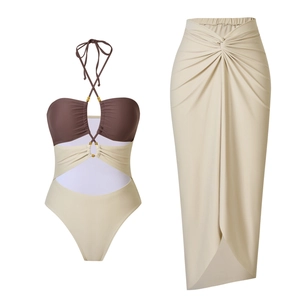 Detail of cutout bodice with gold bead neckties and matching high-waisted wrap skirt