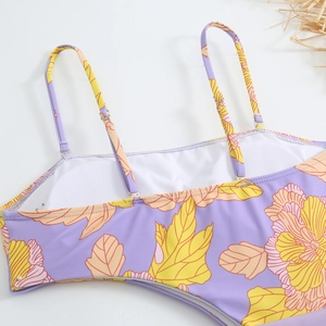 Detail of floral gradient one-piece swimsuit featuring adjustable straps and soft lining