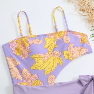 Detail of floral gradient one-piece swimsuit with thin straps and side cut-outs