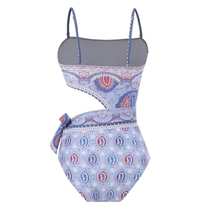 Detail view of back cutout and tie knot on paisley print one-piece swimsuit