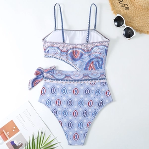 Detailed view of paisley one-piece swimsuit with cutout side and adjustable tie strap