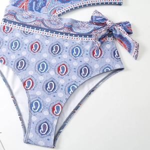 Close-up of vintage paisley print swimsuit featuring side bow-tie lace-up details