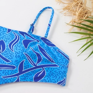 Detail of blue gradient print swimsuit featuring adjustable straps and summer decor
