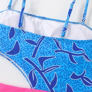 Detail of swimsuit showing blue gradient print, fine stitching, and breathable mesh lining