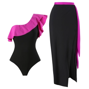 Detail of black one-shoulder swimsuit and side slit skirt with pink ruffle accents