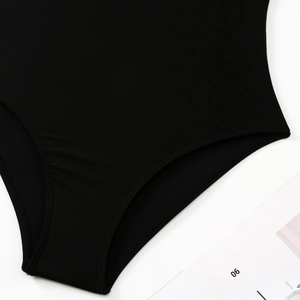 Detailed close-up of the stitching and high-elastic fabric on the black one-piece swimsuit