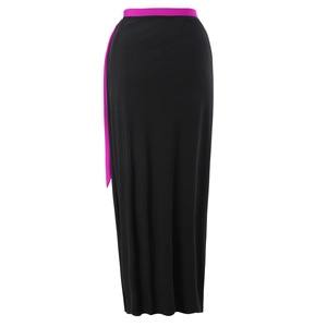 Detail view of the sleek black polyester dress with vibrant fuchsia waist tie and ribbon