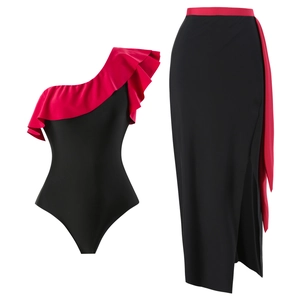 Detail of one-shoulder swimsuit set featuring red ruffle trim and black side-slit skirt