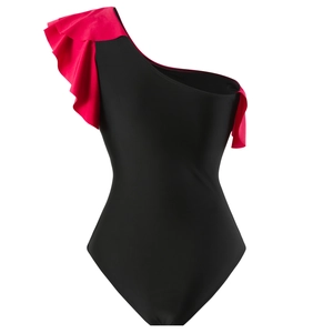 Detail of one-shoulder ruffle swimsuit in red and black contrasting colors with smooth texture