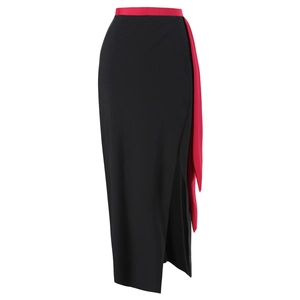 Macro detail of high-waist black swim skirt with red contrast waistband and side tie