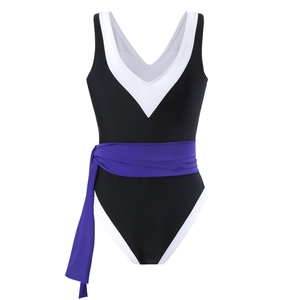 Detail of V-neck one-piece swimsuit with white trim and purple waist tie belt