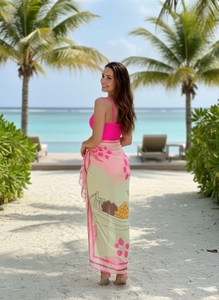 Magenta one-piece swimsuit paired with a long botanical print sarong wrap skirt