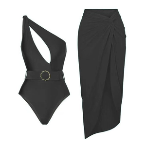 Detail of black one-shoulder cutout swimsuit and matching wrap skirt with gold ring