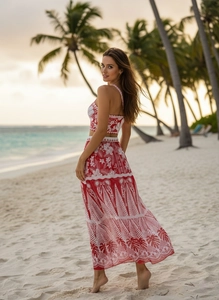 Detail of red tropical floral bikini set with mesh skirt and exotic beach scenery