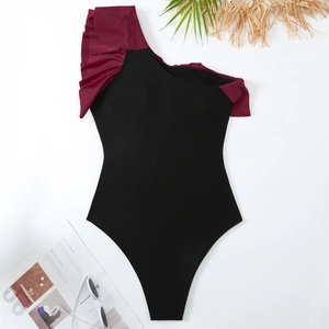 Elegant one shoulder black one-piece swimsuit with red ruffle and summer vacation accessories