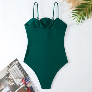 Deep green one-piece swimsuit with slim straps and ruched bust on white background
