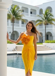 Detail of yellow one-piece swimsuit with 3D floral accent and waist twist detail