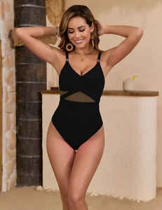 Detail of the mesh waist design and deep V-neckline on this black one-piece swimsuit