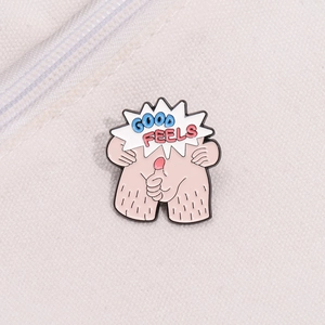 Macro-opname van de grappige Good Feels emaille pin met artistieke letters op stof