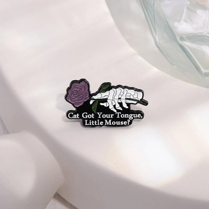 Halloween skeleton hand with purple rose enamel pin featuring cat got your tongue text