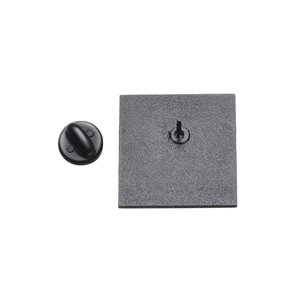 Macro shot of square metal badge back with matte black finish and rubber clutch fastening