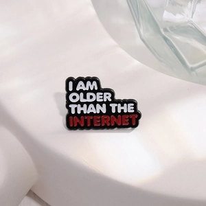 Black rectangular enamel pin with I AM OLDER THAN THE INTERNET slogan for clothing and bags