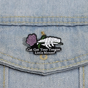 Halloween skeletal hand holding purple rose enamel pin on denim pocket with quote