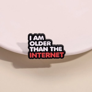 Enamel pin brooch featuring red and white text I AM OLDER THAN THE INTERNET on black metal