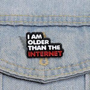 Funny enamel pin badge with I Am Older Than The Internet text on a denim jacket