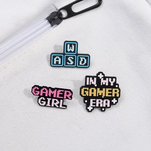 Set of pixel art gaming enamel pins including WASD keys on a white canvas background