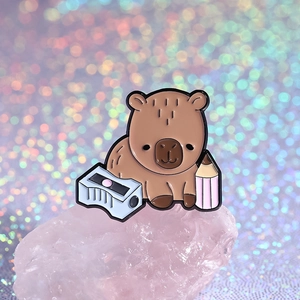 Cute capybara enamel pin badge with pencil and sharpener on pink crystal stone